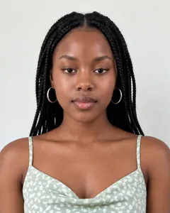 Selected saved model portrait with braids and a sage-green patterned dress